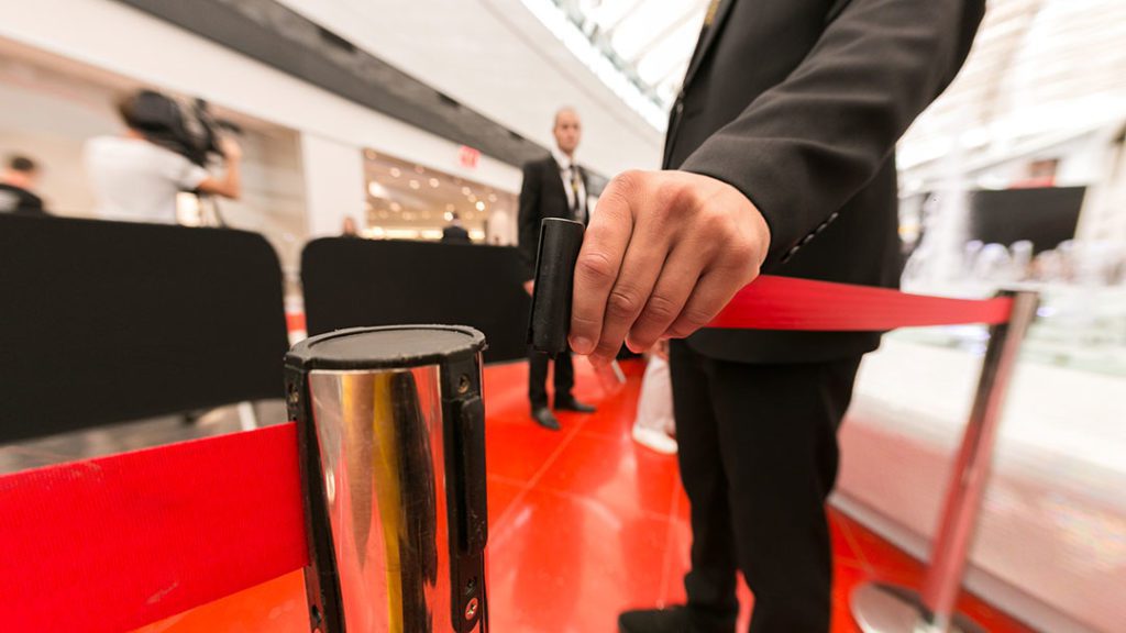 Close up of a hand opening a vip barrier rail - event security - close protection