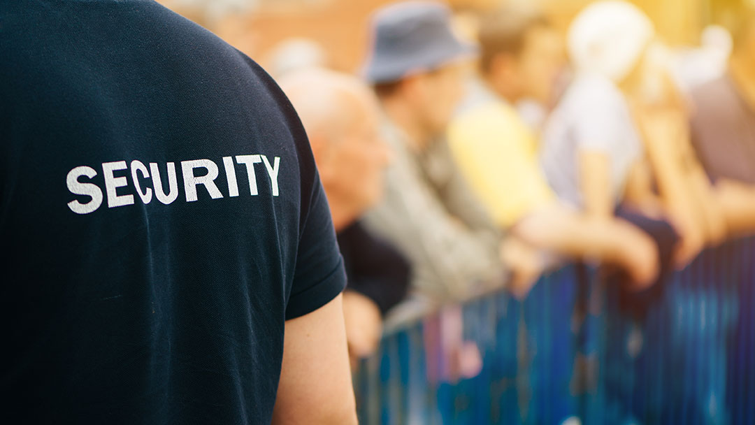 An events security guard on duty at the front of a festival crowd